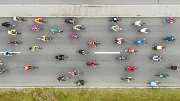 Cyclists Pedal and Compete Along Broad Asphalt Road alt