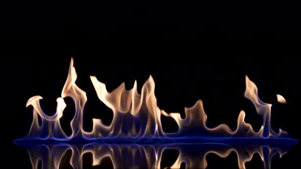 Flash and Fire Streak of Flammable Liquid or Gasoline Against Black Reflective Background alt