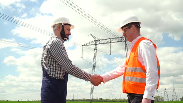 Two Engineers Working Near Transmission Lines alt