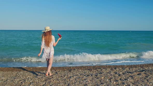 Tall Woman with a Long Hair From a Back is on a Beach alt