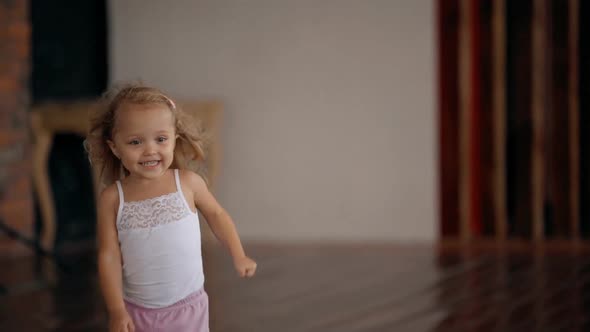 Happy Little Girl Running Through House with Modern Interior in Slow Motion