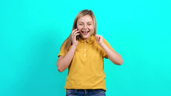 The Happy Young Woman Finds Out Good News on the Phone. alt