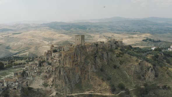 Flying over Craco, old creepy town in Basilicata, Italy 4K