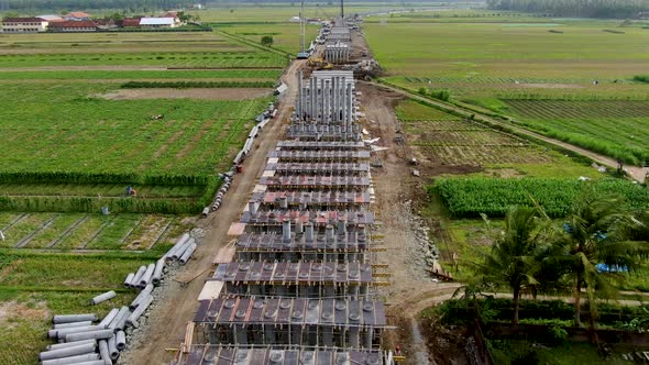 Monorail construction site on Java, aerial view of concrete foundation piles alt