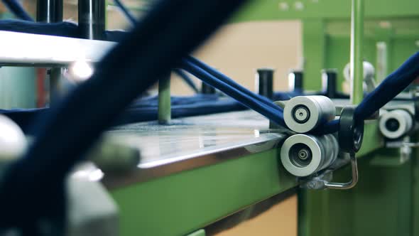 Mechanical Reels with Coloured Yarn Going Through Them alt