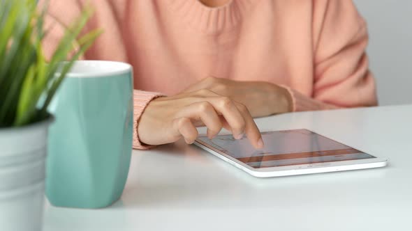 Young Asian women business owners using app smartphone and play the stock market in office.