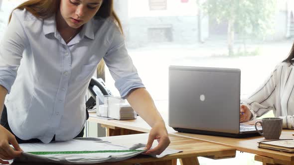 Creative Team of Fashion Designers Working at the Office Together alt