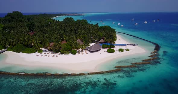Wide angle overhead island view of a white sand paradise beach and turquoise sea background in hi re alt