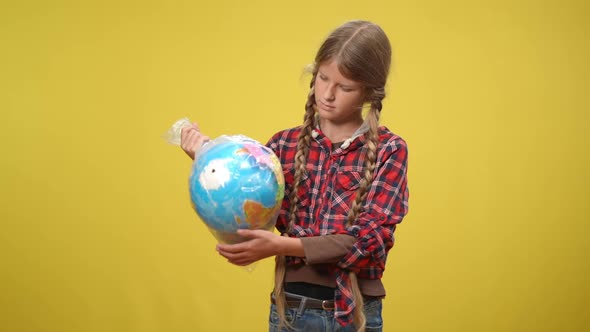 Medium Shot Serious Teenage Girl Posing at Yellow Background with Earth Globe with Eco Messages alt