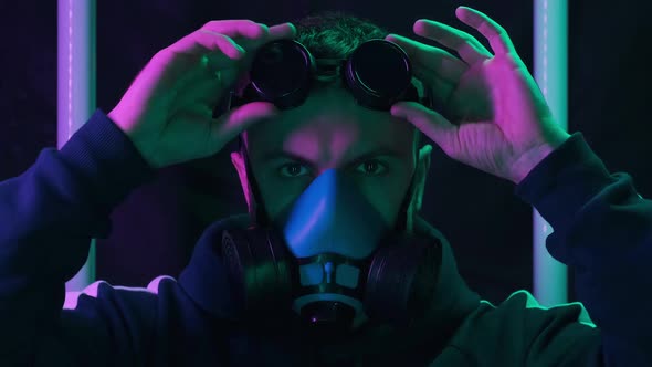 Portrait of Man in Respirator Wearing Protective Glasses with Blinking Lights alt