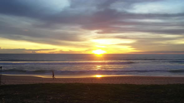 A Man Joking On The Beach At Sunset alt
