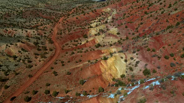Aerial view over orange and yellow rock formations in vermillion cliffs, utah. alt