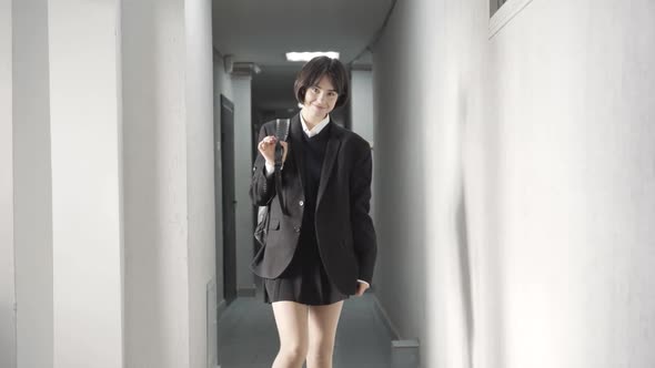 Portrait of Pretty Positive Teenage Girl Posing in High School Corridor alt