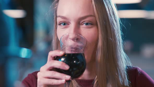 Beautiful Caucasian woman clinking glasses and drinking beer