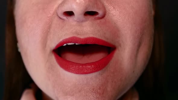 Woman with Lips Painted with Red Lipstick Sings Song Opening Mouth Wide on