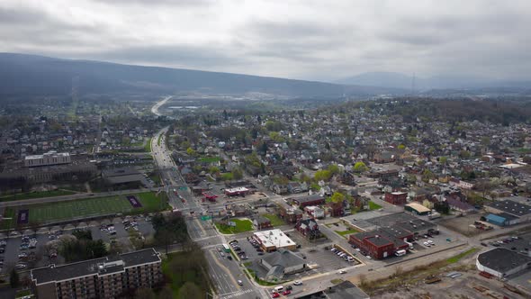 Aerial drone timelapse flying over small, rural downtown of Altoona Pennsylvania in the summer showi alt