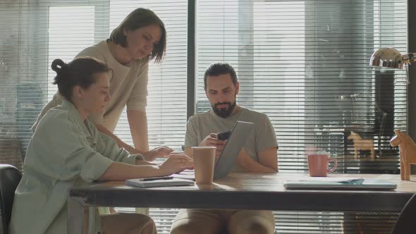 Friends are Working Together on a Common Project Smiling and Laughing alt