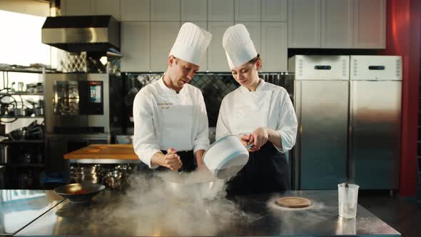 Professional kitchen: liquid nitrogen is added during the cooking of a molecular dish alt