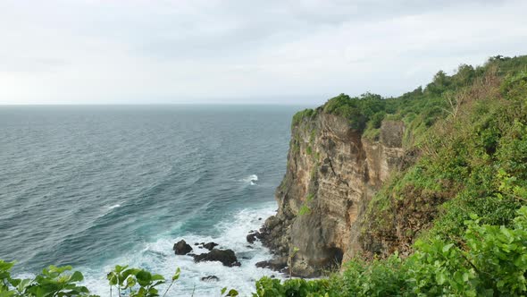 Beautiful Green Uluwatu Temple Cliff and Turquoise Water of Indian Ocean Bali