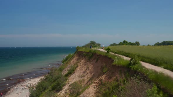 Peaceful Coastline Scenery Aerial Drone Flying Above Foot Walk Path with Blue Turquoise Baltic Sea alt