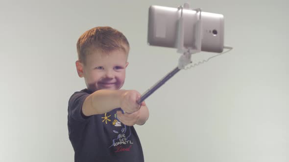Little boy taking selfie alt
