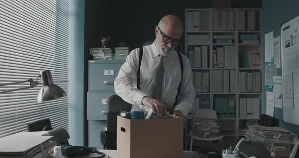 Employee packing his belongings and leaving the office