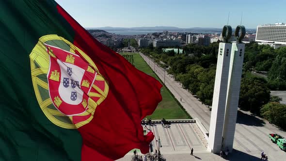 Close Up Aerial View of Portugal Flag Waving in the Wind on Eduardo VII Park Lisbon alt