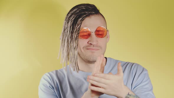 Young Handsome Man in Sunglasses Blue Tshirt Looking at Camera Applauding with Hands alt