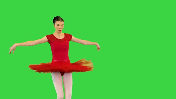 Young Ballerina in Red Classical Tutu Performs Fouette on a Green Screen Chroma Key alt