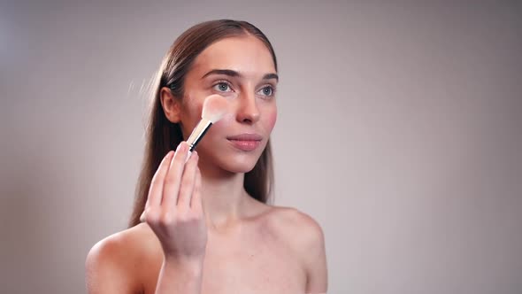 Beautiful Girl Using Make Up Brush