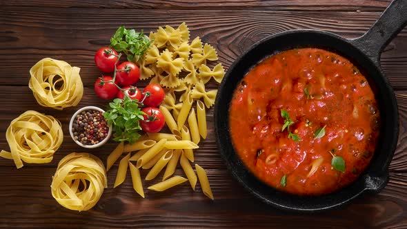 Cooking Pasta Penne with Tomato Sauce and Basil 
