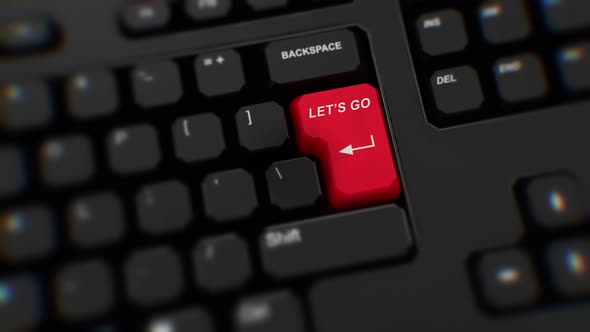 Let's Go red button on keyboard. A finger presses Enter. Click Let's Go. Realistic keyboard button. alt