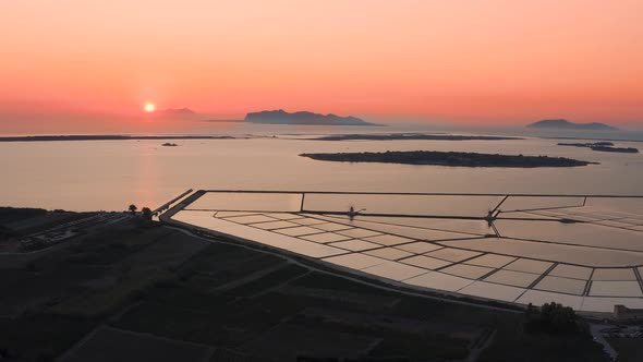 Drone shot of of sunset in Saline di Marsala, Salt pans in Island of Sicily Italy 4K