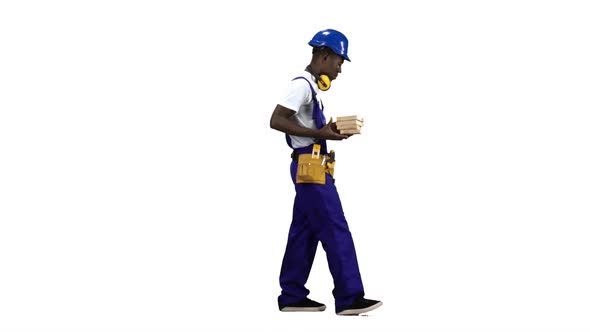 African American Builder Goes To Work with Wooden Planks in His Hands. Alpha Channel. Side View alt