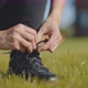 Close Up of Sporty Woman Crouching Outdoors in Sportswear and Tying Shoelace - VideoHive Item for Sale