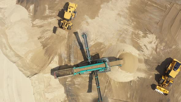 Aerial view loading bulldozer in open air quarry. Sand mining industry. Bulldozer machine. Crawler b alt