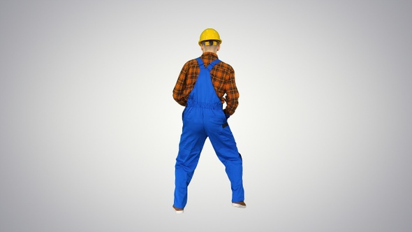 Construction worker in helmet dancing on gradient background. alt