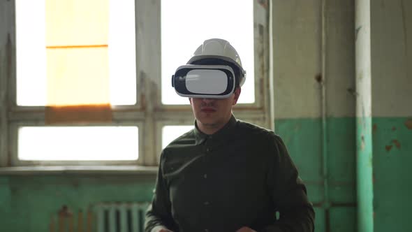 An Engineer Wearing Virtual Reality Glasses Moves Digital Objects with His Hands