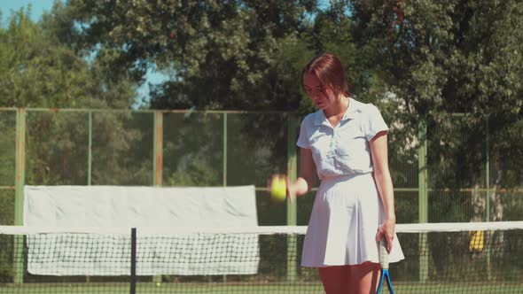 Female Tennis Player Practicing Hits on Court