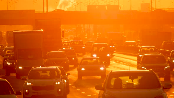 Urban street cars traffic city sun road sunset. Sunrise cars slow motion.  Silhouette city cars sun
