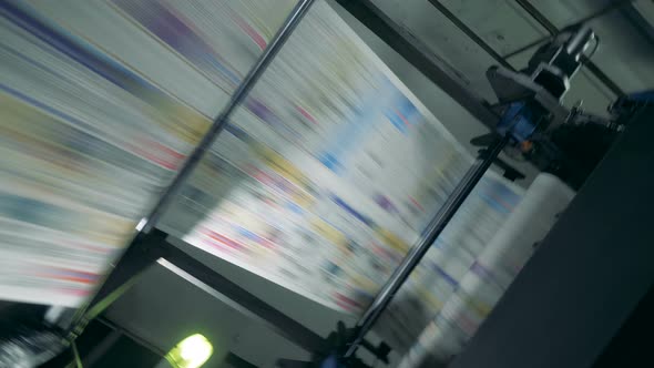 Colored Sheets on a Conveyor at a Printing Office alt