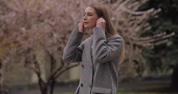 Woman Puts on Wireless Earphones Slow Motion alt