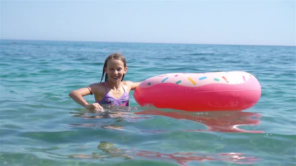 Adorable Girl on Inflatable Air Mattress in the Sea