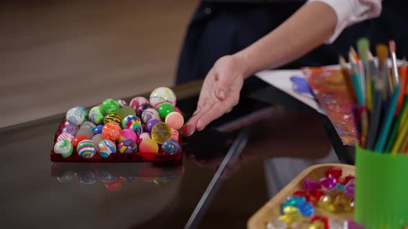 Hand of Kid Choosing Colored Ball at Therapist alt