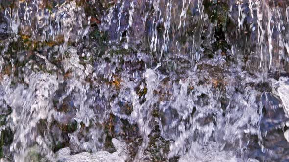 the Flowing Water Small Rapid Waterfall on River in Slow Motion at Daylight alt