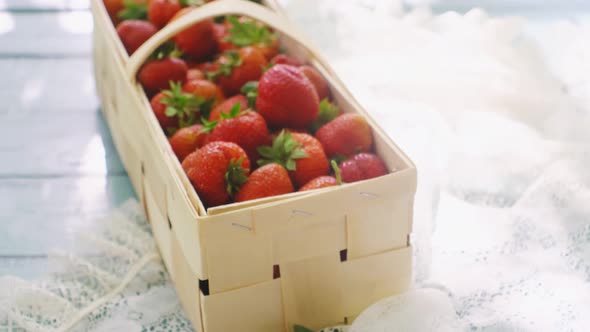 Summer Picnic with Strawberries on the Grass and Full Basket