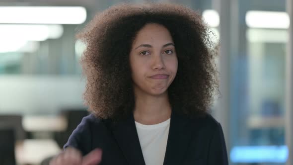 Portrait of Thumbs Down By African Businesswoman alt