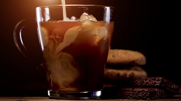 Pouring Milk into of Cold Brew Coffee  alt