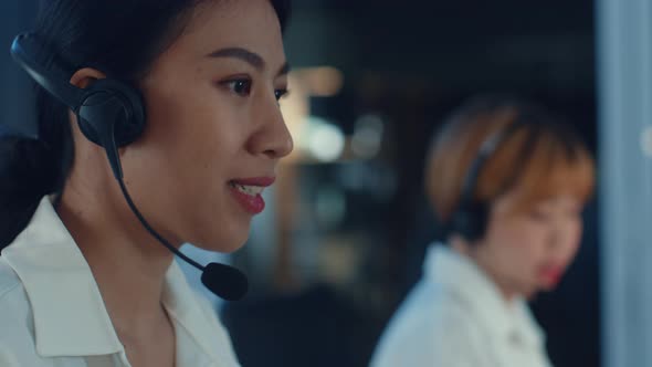 Asia young call center team or customer support service executive using computer and microphone.