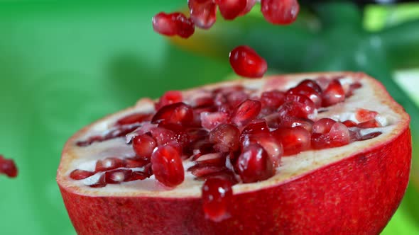 Super Slow Motion Shot of Falling Seeds on Fresh Pomegranate at 1000Fps alt